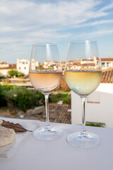 Summer on French Riviera Cote d'Azur, drinking cold rose and white wine from Cotes de Provence on outdoor terrase in Port Grimaud, Var, France