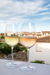 Summer on French Riviera Cote d'Azur, drinking cold rose and white wine from Cotes de Provence on outdoor terrase in Port Grimaud, Var, France