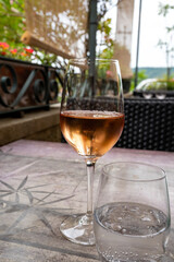 Obraz premium Summer on French Riviera Cote d'Azur, drinking cold rose wine from Cotes de Provence on outdoor terrase in cafe