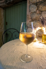 Summer on French Riviera Cote d'Azur, drinking cold rose from Cotes de Provence on outdoor terrase in old cafe, Var, France