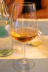 Summer on French Riviera Cote d'Azur, drinking cold rose from Cotes de Provence on outdoor terrase in old cafe, Var, France