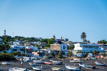 Stromboli island (Aeolian archipelago), Lipari, Messina, Sicily, Italy, 08.21.2021: view of the village   with many boats on the black lava beach.