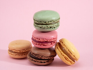 colorful macarons on pink background