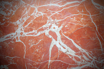 The marble wall is red. Red background with marble texture and vignette.