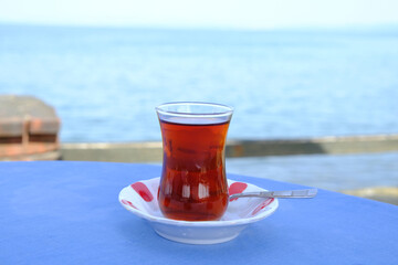 glass of tea on the table with sea view