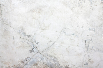 The concrete wall with scuffs and cracks is light gray. Light gray background with cement texture.