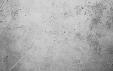 A concrete wall with dots and scuffs of gray color. Grey background with cement texture.