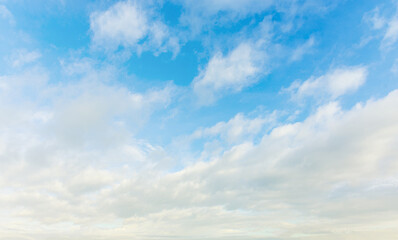 Naklejka na ściany i meble Blue sky and fluffy white clouds floating in the sky.