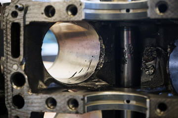Close-up view of damage to the walls of the engine cylinder. Scratches and scuffs caused by the...