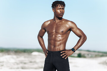 Portrait african american man, fitness athlete, with muscular naked torso, outdoors in nature