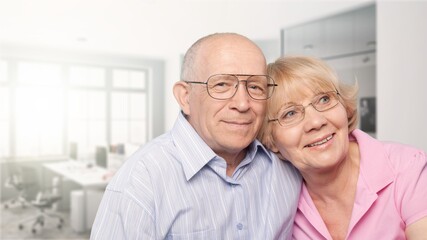 Happy older mature classy couple hugging, thinking of good future.