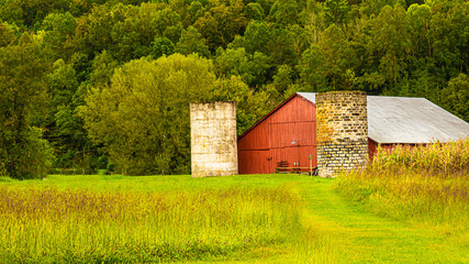 Red barn with two silos. © Jim
