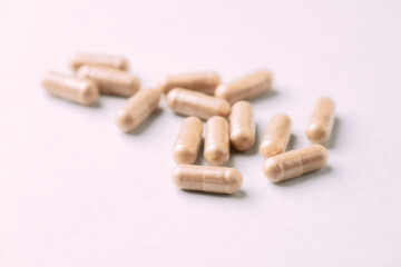 Hop Extract Capsules. Bright paper background. Close up. 