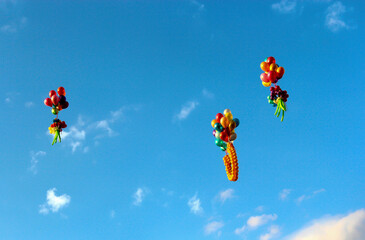 Red, orange, yellow, green, blue, purple and other colorful balls fly into the sky