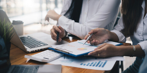 Fototapeta premium Analytics intelligence concept. Group of business people discuss current financial and economic on laptop for investment at the meeting