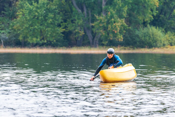 A solo canoeist practices stroke techniques on a rainy fall day as part of a &ldquo;moving water&rdquo; paddling course. Shot on the Madawaska River an iconic paddling destination in Eastern Ontario, Canada.