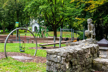 A playground in the park and a chapel in the background