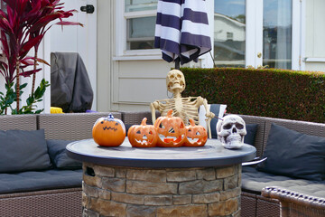 halloween decorations with carved pumpkins, skull and skeleton