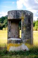 An old concrete barrier with moss and fall colors
