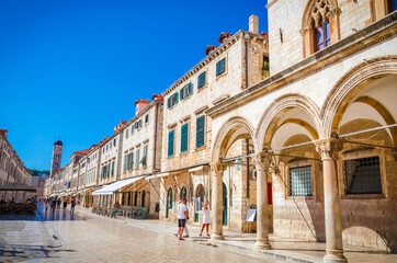 Famous narrow street and old city walls in Dubrovnik, Croatia