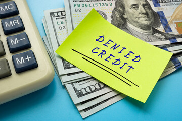 Financial concept about DENIED CREDIT with inscription on the sheet.