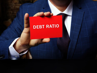  Financial concept about DEBT RATIO with phrase on the piece of paper. Business photo shows the...