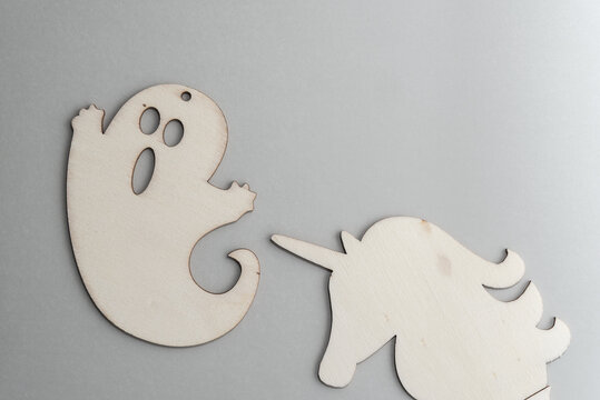 ghost frightened by a unicorn - wooden laser cut plywood shapes on paper