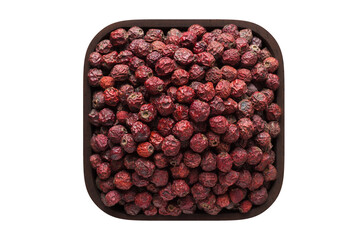 dried hawthorn berries in square bowl isolated on white background. organic food, top view.