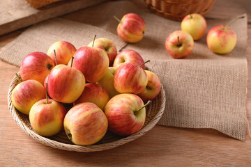Fresh red apple fruit in a basket on wooden background, Still Life