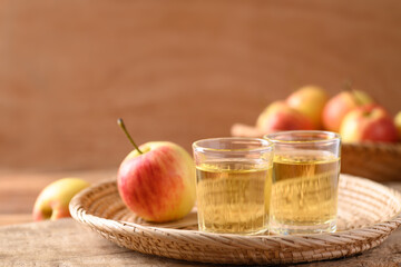 Fresh red apple fruit and juice in a basket on wooden background