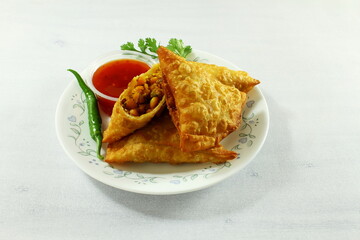traditional indian gujarati food tea time snack vegetable chana dal samosa with chilli tomato sauce top view