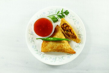 traditional indian gujarati food tea time snack vegetable chana dal samosa with chilli tomato sauce top view