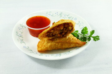 traditional indian gujarati food tea time snack vegetable chana dal samosa with chilli tomato sauce top view
