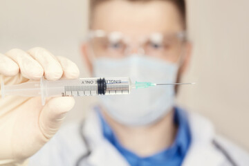 Doctor holding a syringe with vaccine against corona virus.