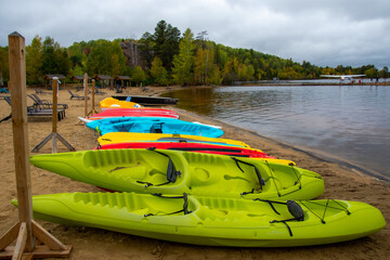 Fototapeta premium Canoe and kayak on the beach of a wild lake in the Canadian forest in Quebec