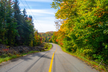 Fall colors in the Canadian countryside with road in the province of Quebec