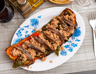 Appetizing Spanish snack Torrada de atun, made from tuna toast, bell pepper, onion and a small eggplant