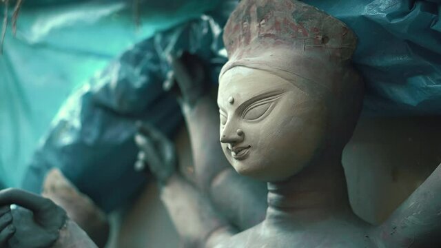 Kolkata, India : Beautiful unfinished idol of Goddess Durga captured from left side in a close up shot; uncolored clay model of Maa Durga captured using soft focus.