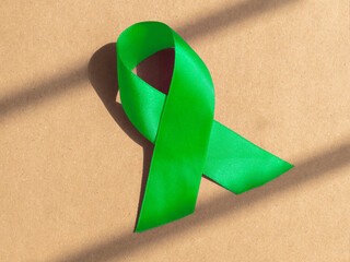 Green ribbon as symbol of mental awareness day.