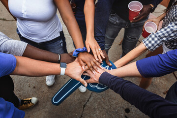 Sports fans in a huddle at a tailgate event