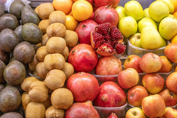 Pomegranate, kiwis and other fruits for sale at a market