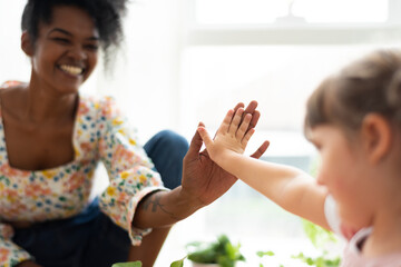 Multiracial family at home doing a high five