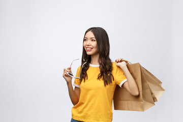 Fototapeta na wymiar Beautiful Attractive Asian Woman smile and holding shopping bags feeling so happiness and enjoy with black Friday sale in Shopping mall,isolated on white background,Shopping Concept.
