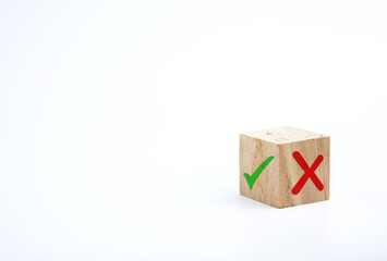 Checklists and quizzes. cross and a check mark on wooden cube. concept of denial wrong answer and correct answer, right decision. with copy space for business designs
