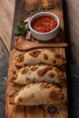 Salta meat empanadas on a wooden base