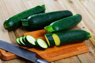 Vegetable ingredients for cooking, sliced zucchini on wooden table