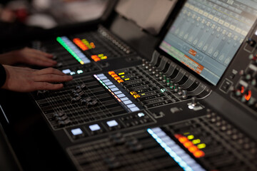 sound engineer at work with digital mixing console