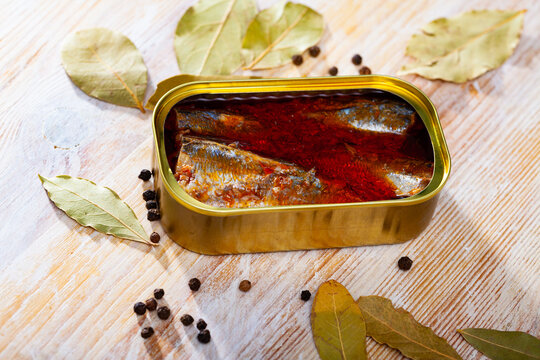 Canned sea fish, mackerel fillets in tomato served with peppers and bay leaf. High quality photo