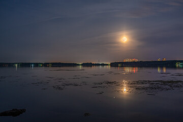 Super full blood moon and moon light over the nigt lake