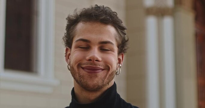 Outdoor portrait of young elegant fashionable Latin man. Cinematic 4K